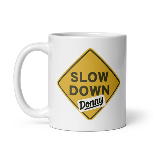 White ceramic mug with a 'Slow Down, Donny | We Have Our Limit Too' graphic by State Limit Apparel.