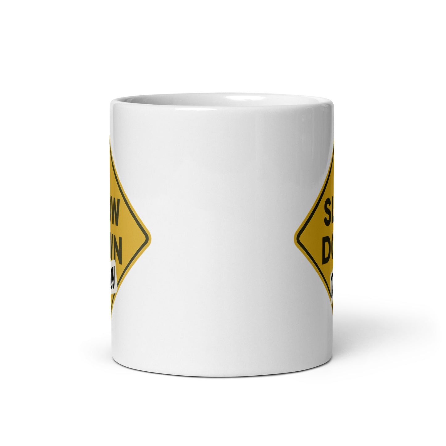 View of white ceramic mug with road sign inspired graphic by State Limit Apparel to both sides.