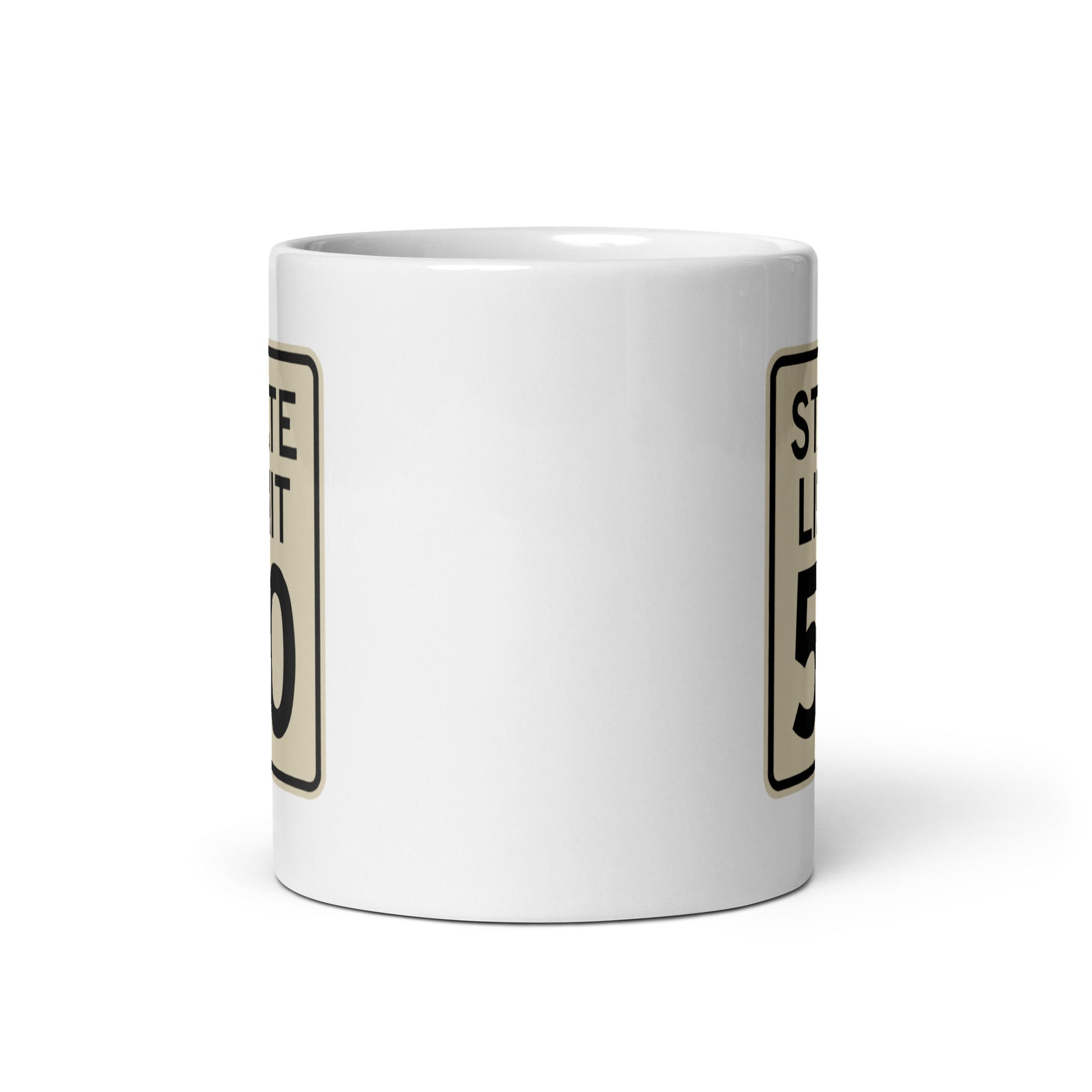 View of white ceramic mug with road sign graphic by State Limit Apparel to both sides.
