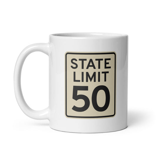White ceramic mug with a 'State Limit | Keep Canada Canadian' road sign graphic by State Limit Apparel.