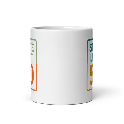 View of white ceramic mug with road sign graphic by State Limit Apparel to both sides.
