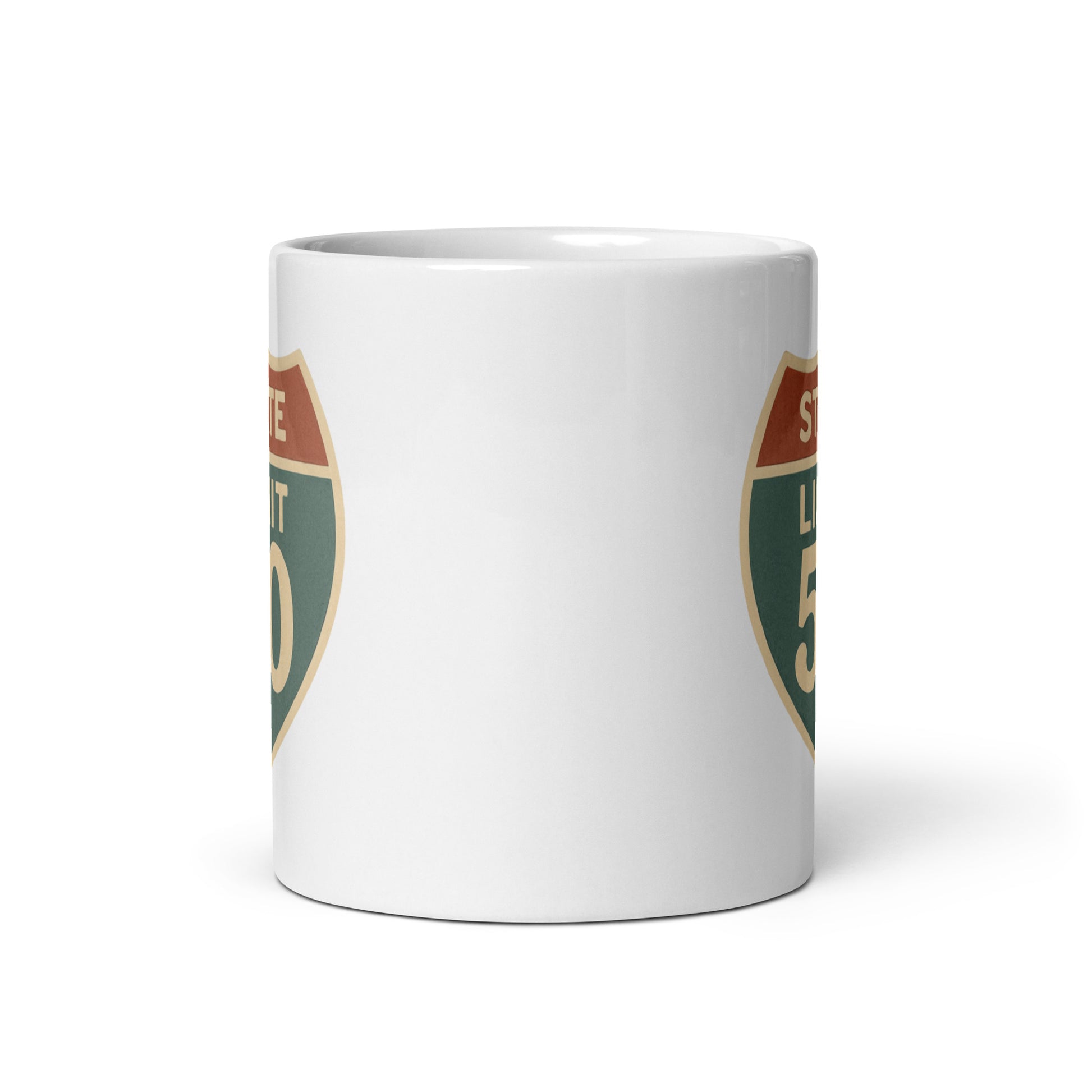 View of white ceramic mug with road sign graphic by State Limit Apparel to both sides.